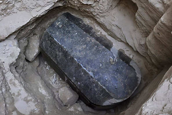 This picture released on July 1, 2018, by the Egyptian Ministry of Antiquities shows an ancient tomb dating back to the Ptolemaic period found in the Sidi Gaber district of Alexandria. - The tomb, which dimensions are a height of 185 cm, length 265 cm and width of 165 cm, contains a black granite sarcophagus considered to be the largest to be discovered in Alexandria. The tomb was found at a depth of 5 meters beneath the surface of the land, there is a layer of mortar between the lid and the body of the sarcophagus indicating that it had not been opened since it was closed in antiquity. An alabaster head of a man was also found and most probably belongs to the owner of the tomb. (Photo by - / various sources / AFP) / XGTY / === RESTRICTED TO EDITORIAL USE - MANDATORY CREDIT 'AFP PHOTO / HO / EGYPTIAN MINISTRY OF ANTIQUITIES- NO MARKETING NO ADVERTISING CAMPAIGNS - DISTRIBUTED AS A SERVICE TO CLIENTS == (Photo credit should read -/AFP/Getty Images)